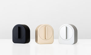 A collection of 3 Sesame devices in black, gold and white